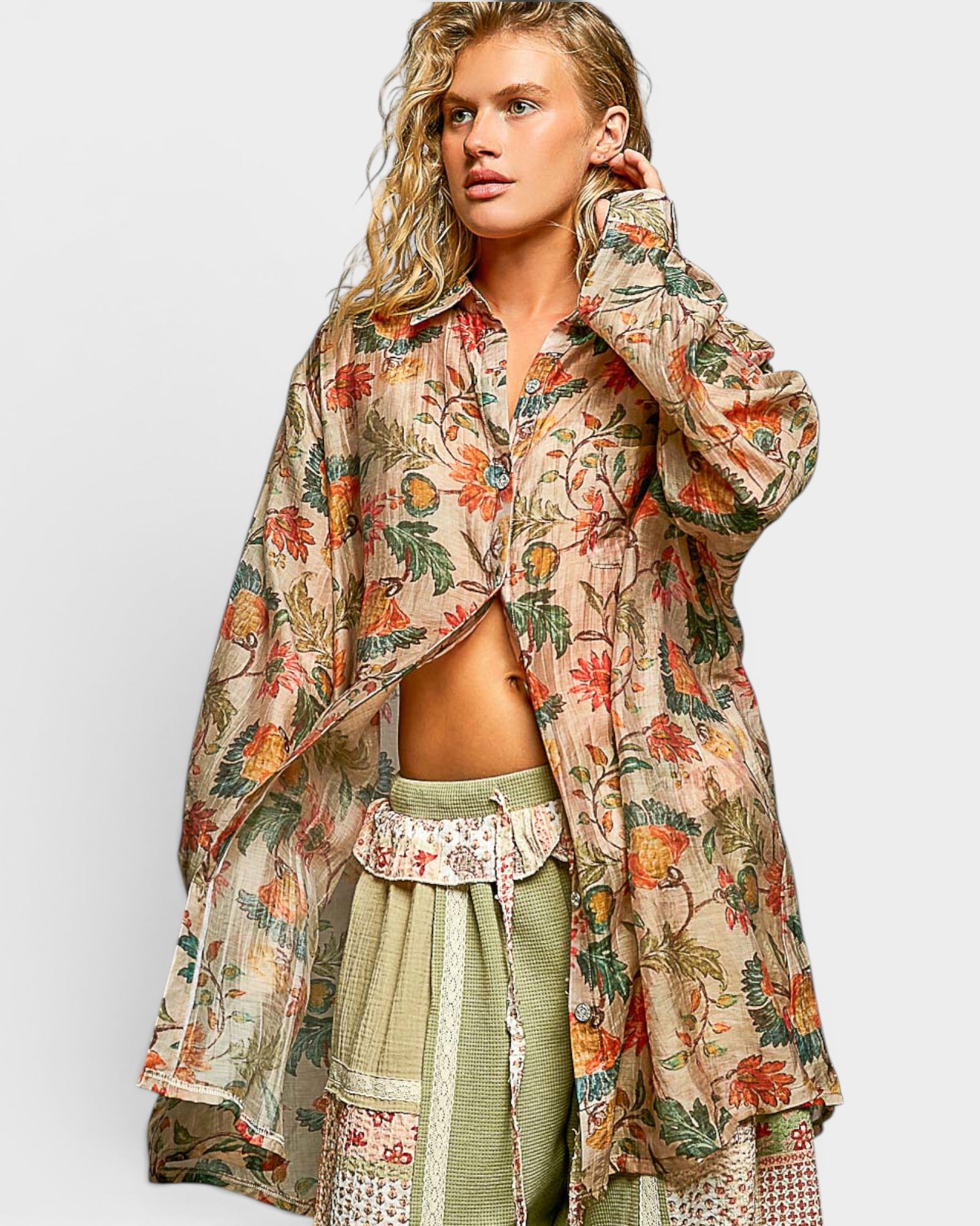 Woman wearing a floral patterned outfit on a plain background