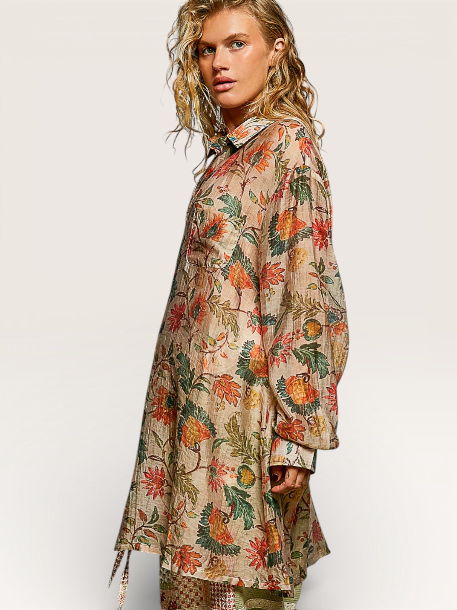 Woman wearing a floral patterned dress against a white background