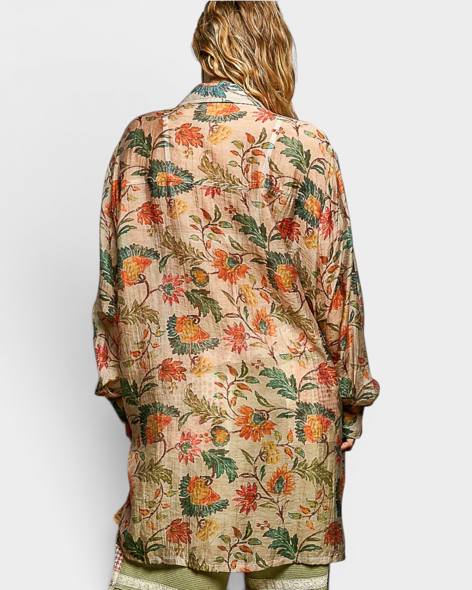 Woman wearing a floral patterned shirt on a white background