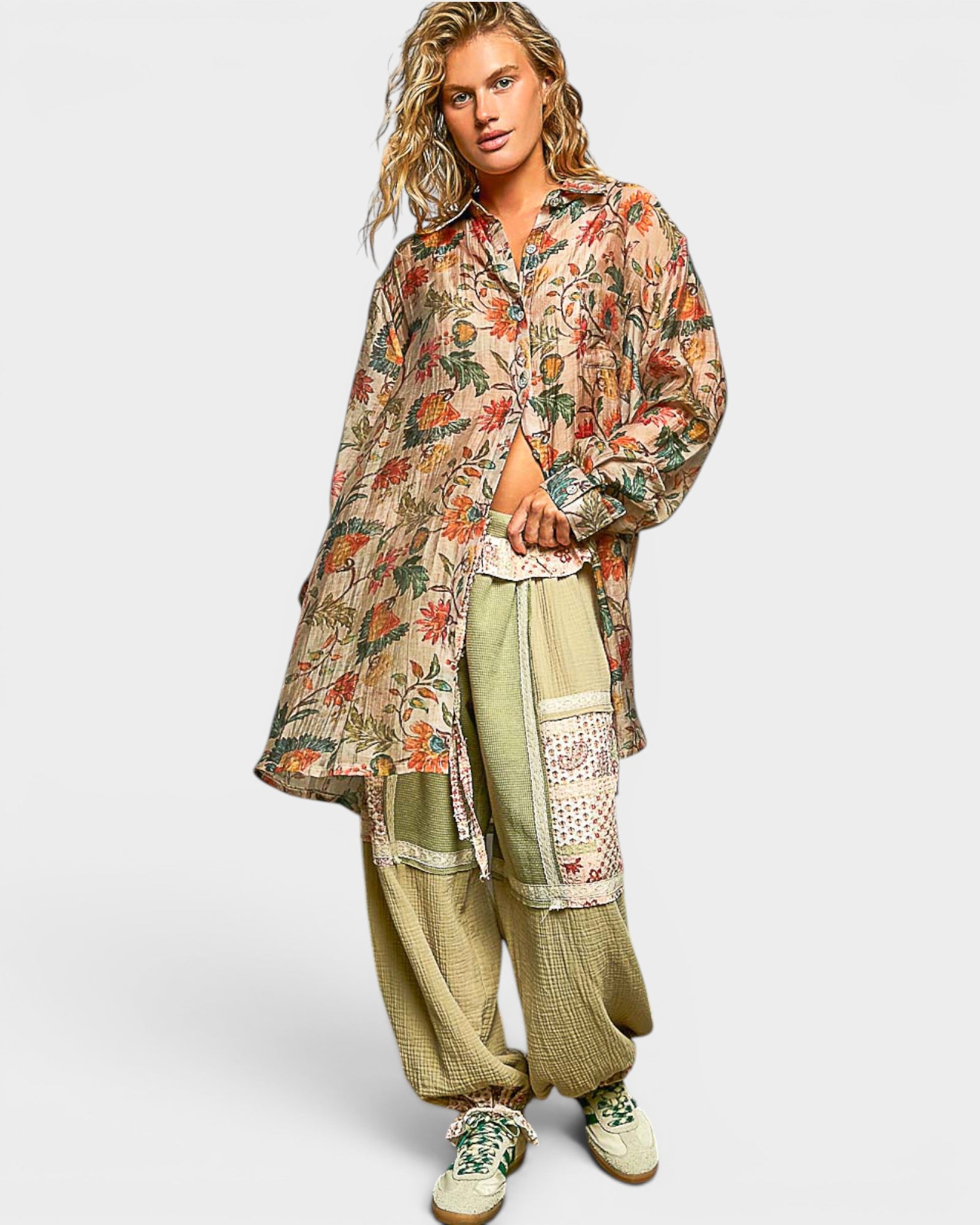 Woman wearing a floral kimono-style top and wide-leg pants on a white background