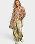 Woman wearing a floral kimono-style top and wide-leg pants on a white background