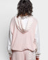 Person wearing a pink checkered outfit with a white background
