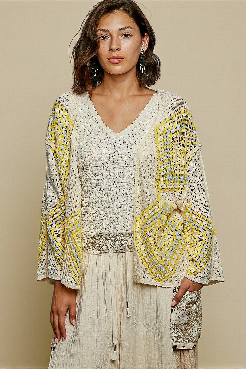 Woman wearing a patterned top with a beige background