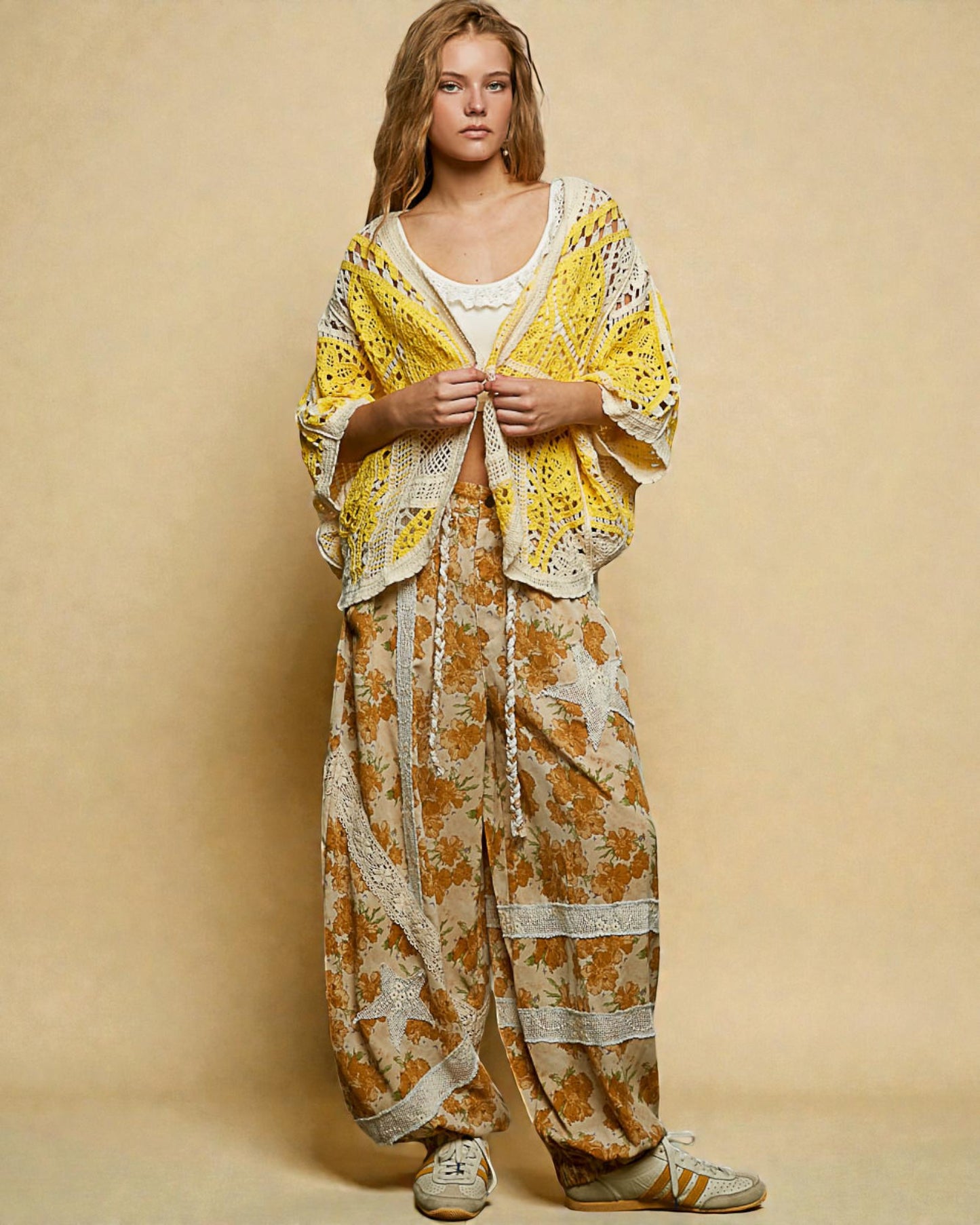 Woman wearing a yellow floral outfit against a beige background