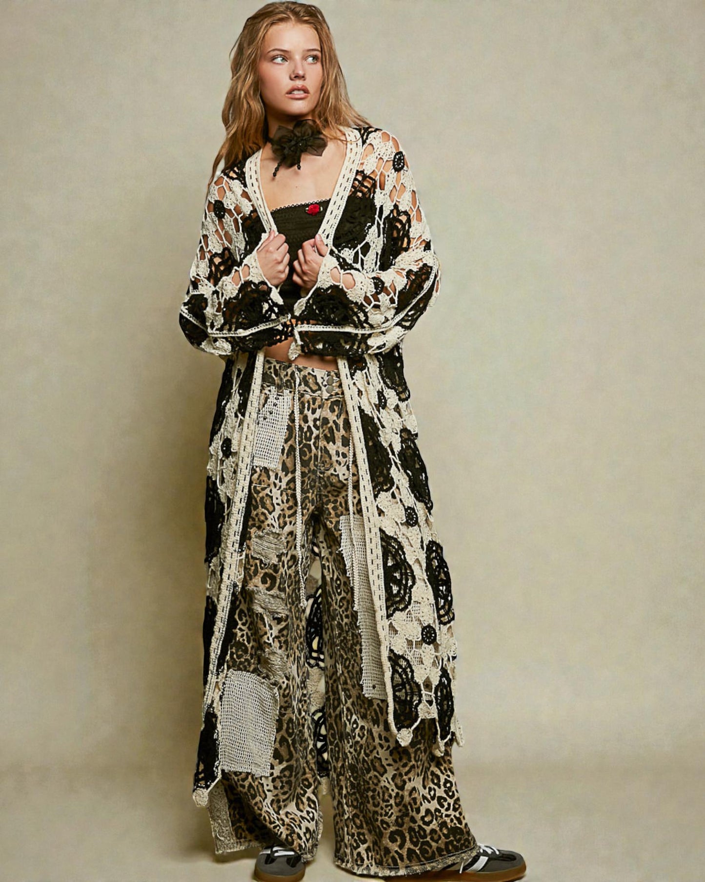 Woman wearing a long, patterned dress with a neutral background