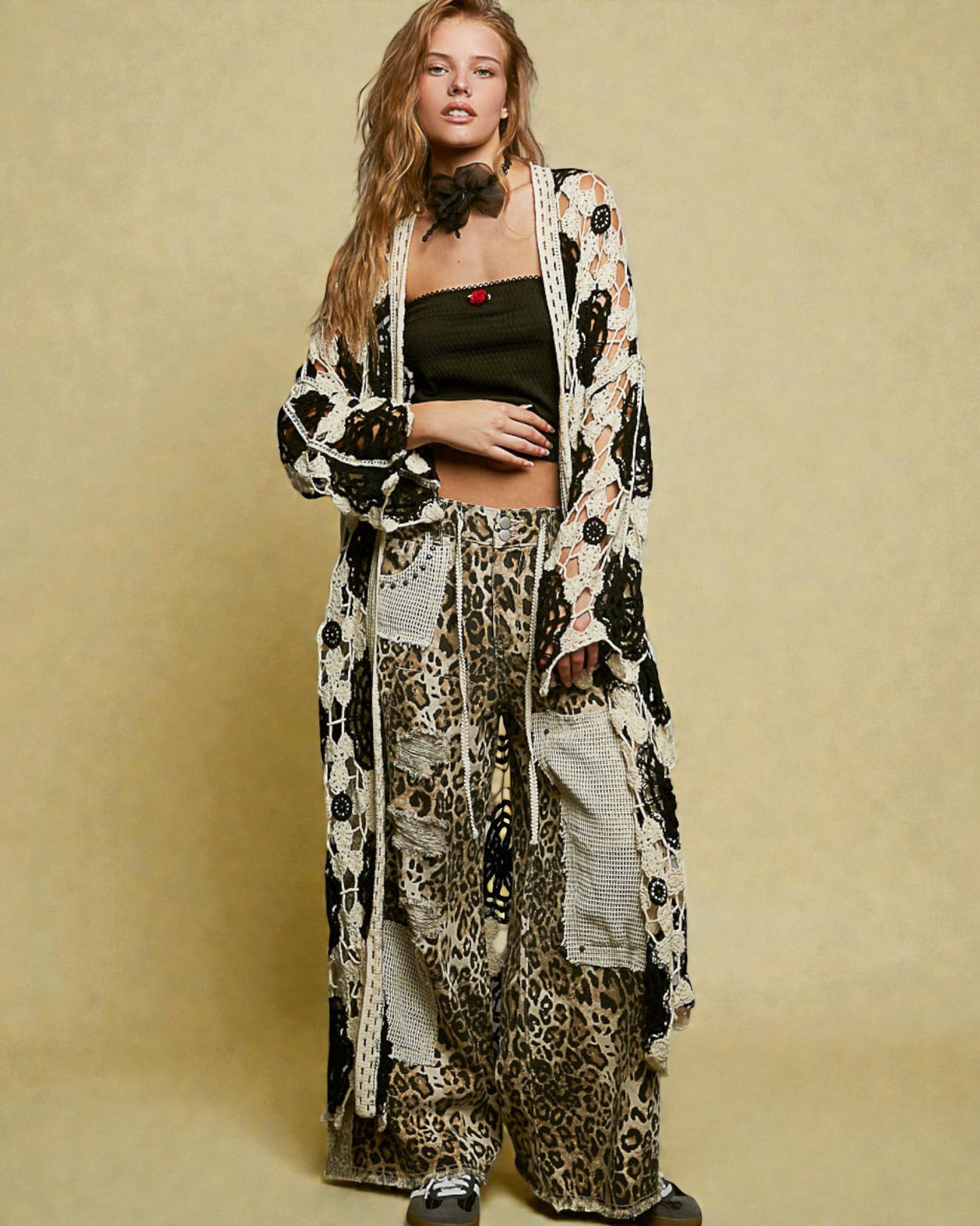 Woman wearing a long, patterned kimono-style garment against a beige background