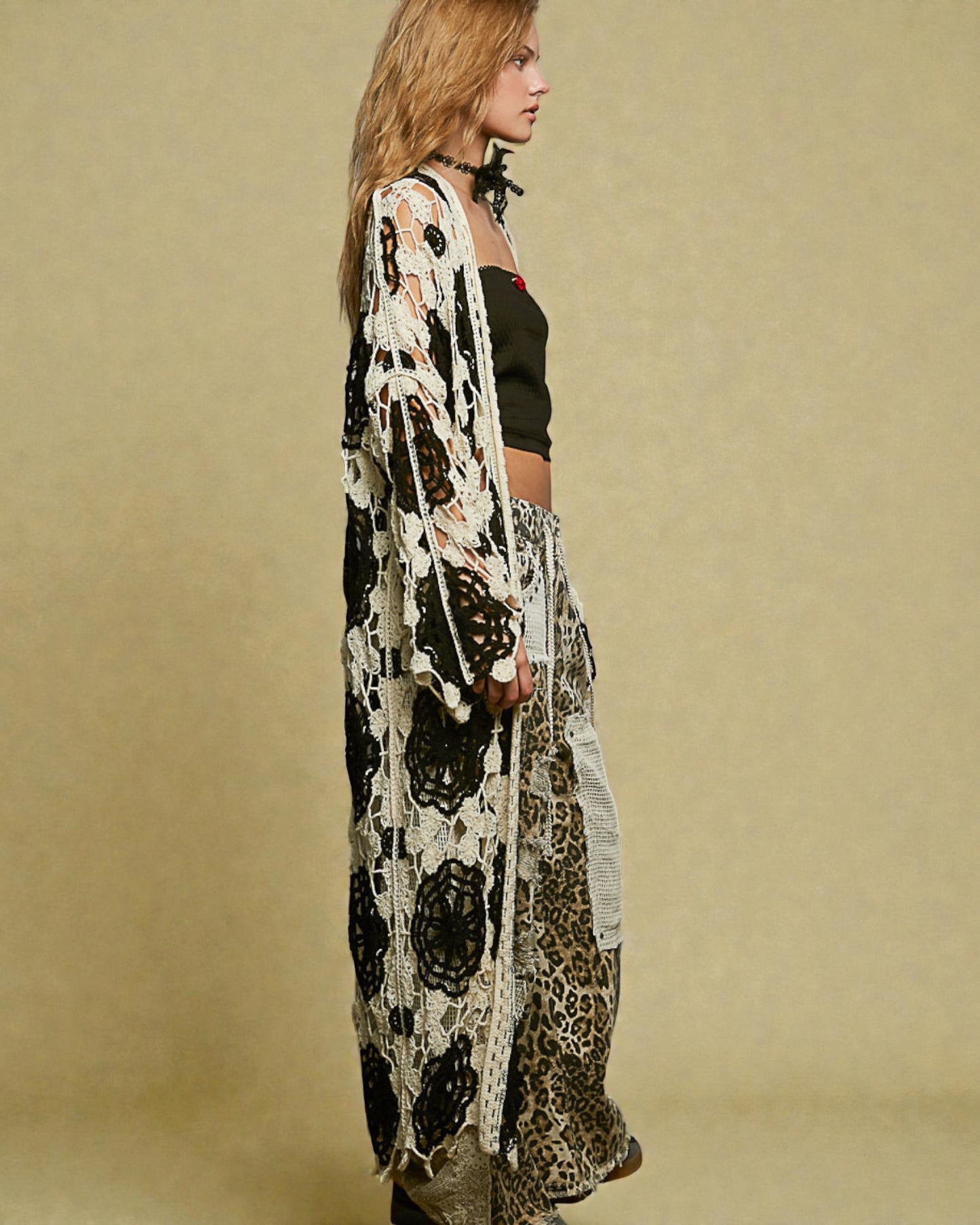 Woman wearing a long, patterned kimono-style garment against a beige background