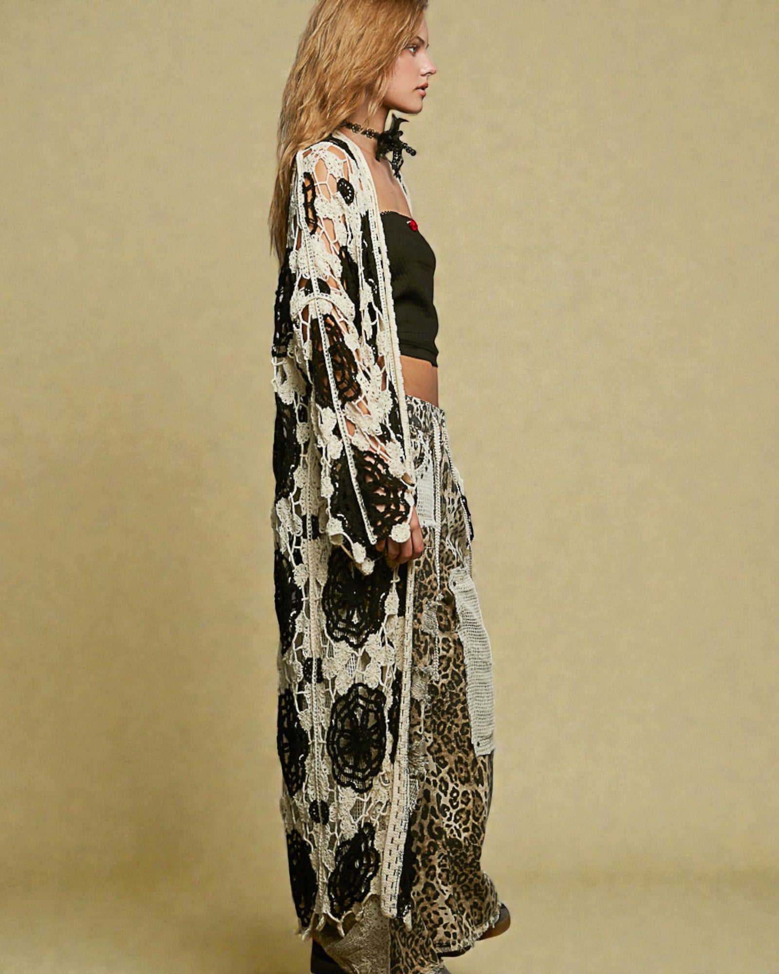 Woman wearing a long, patterned kimono-style garment against a beige background