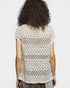 Person wearing a patterned top with a plain background