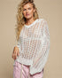 Woman wearing a white crochet top against a beige background