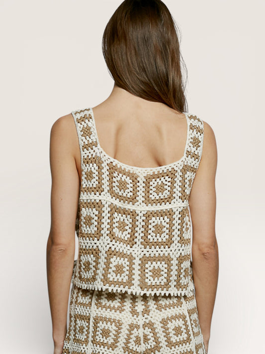 Woman wearing a patterned dress with a neutral background