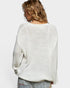 Person wearing a light gray sweater on a white background
