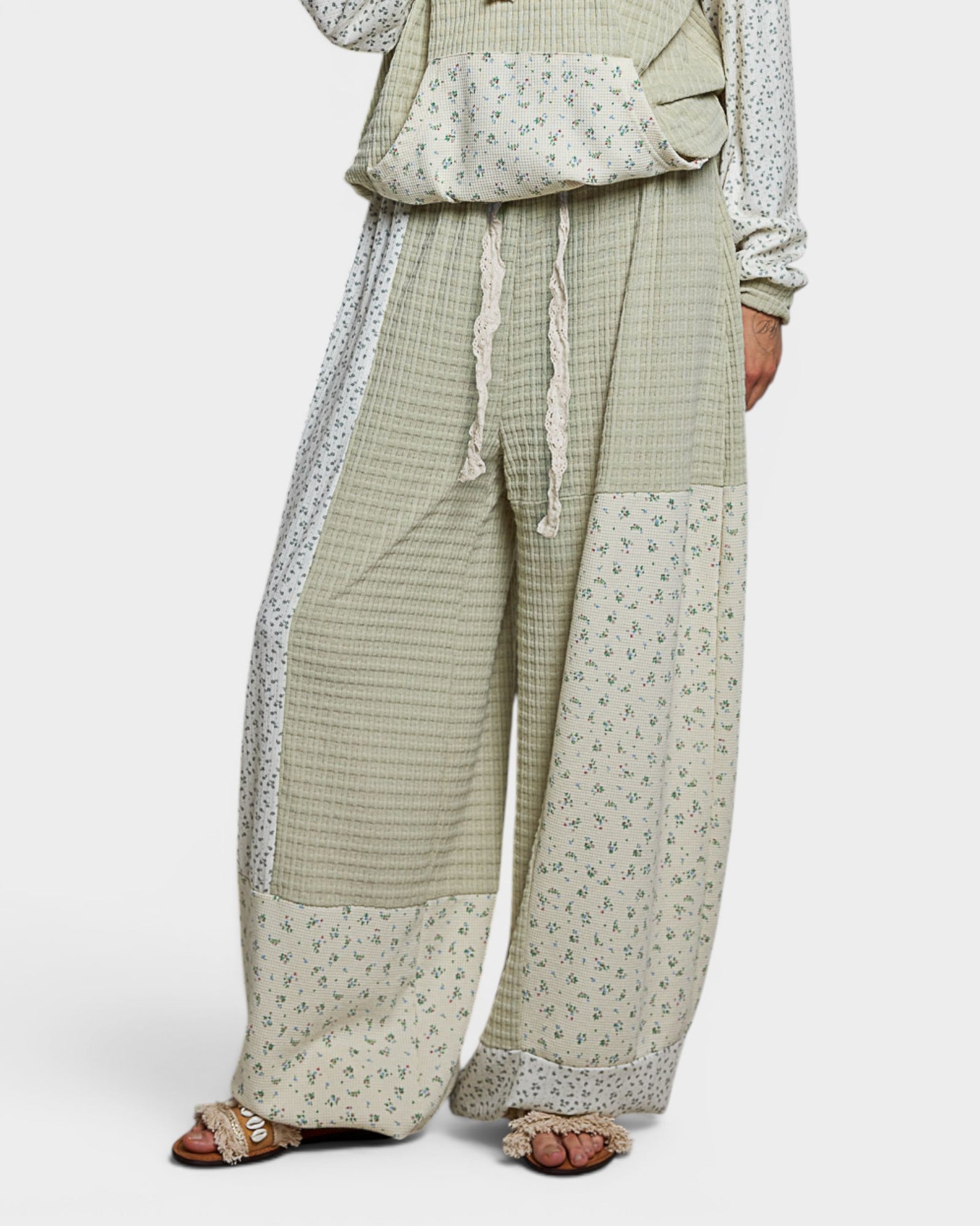 Green checkered outfit with floral patterns on a white background