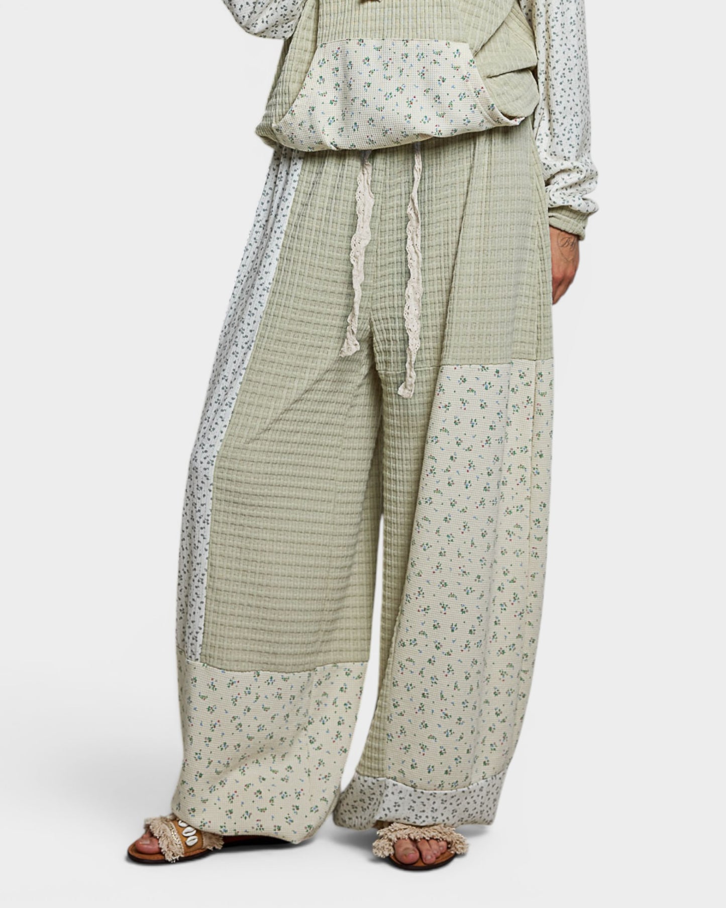 Green checkered outfit with floral patterns on a white background