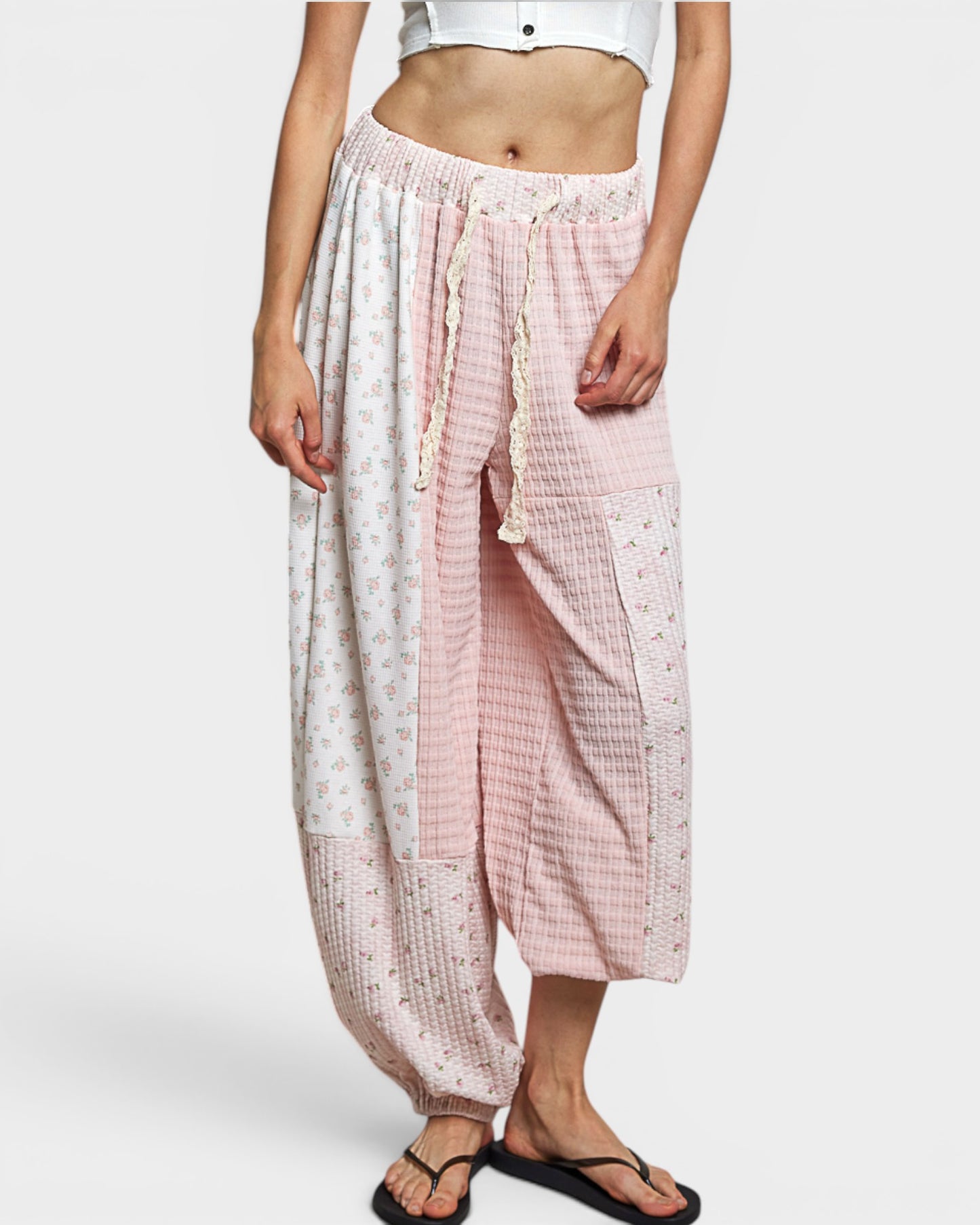 Person wearing pink and white checkered pants on a white background