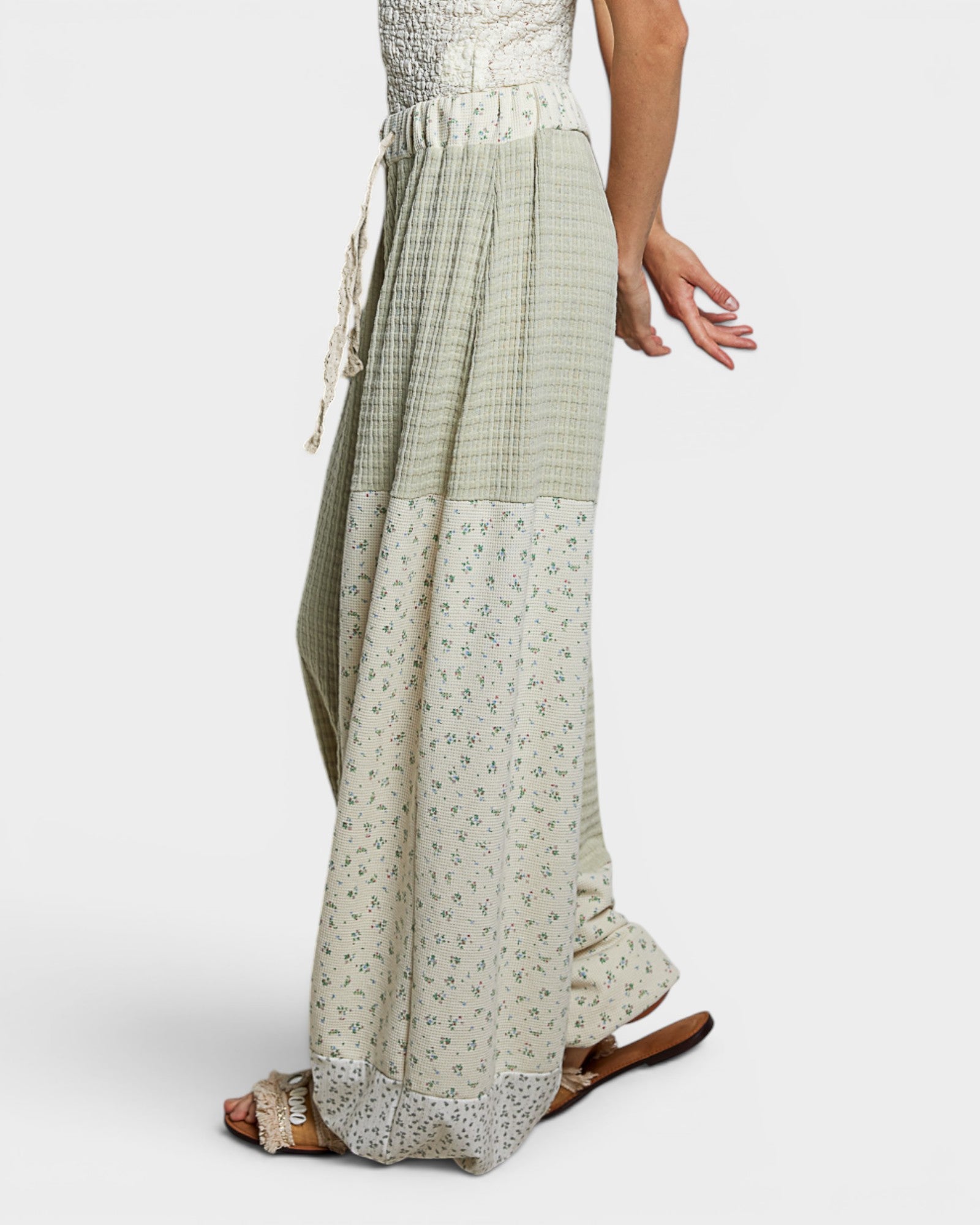 Long, patterned skirt worn by a person on a white background