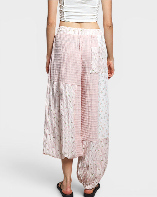Person wearing patterned pants on a white background