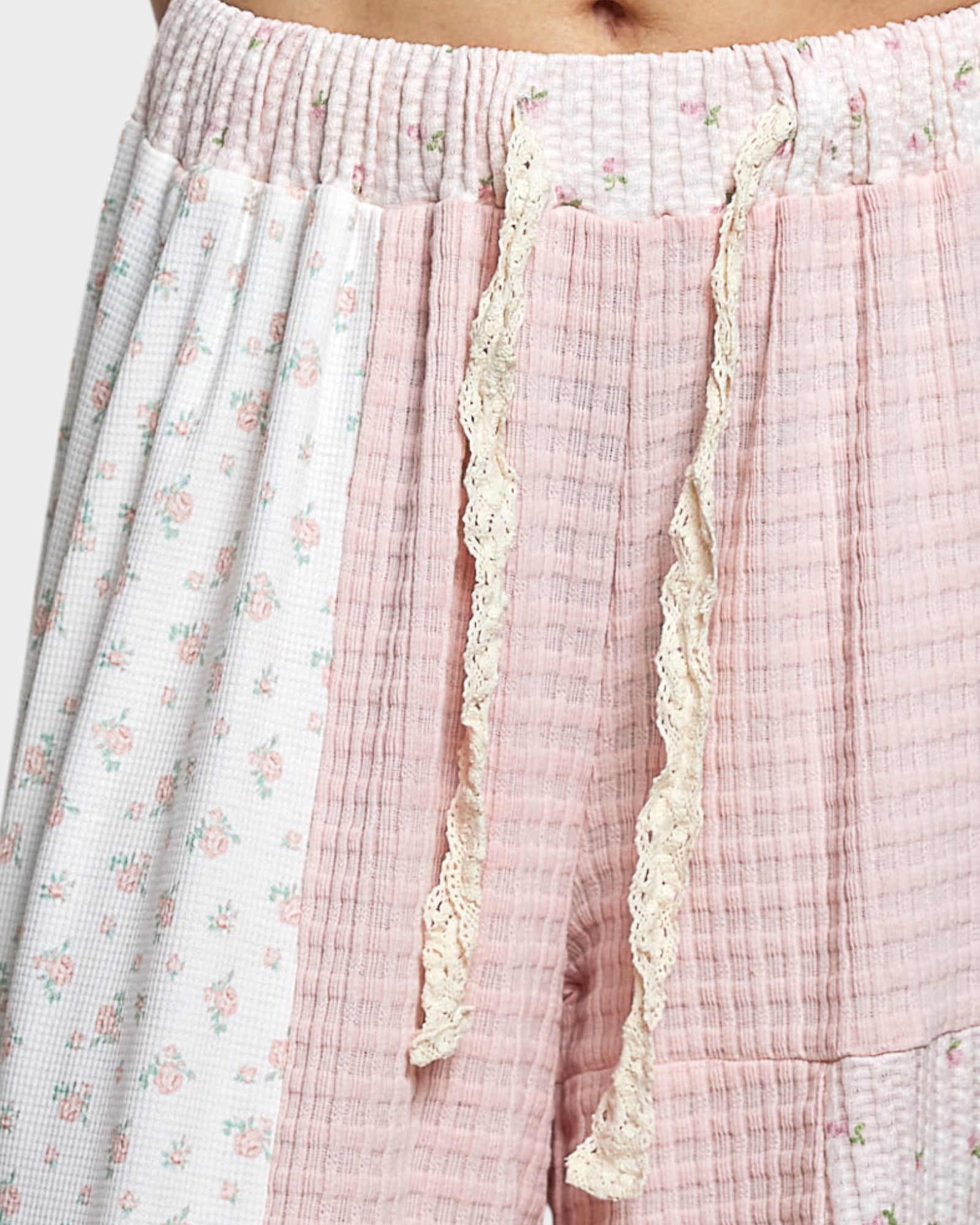 Close-up of pants with floral and checkered patterns on a white background