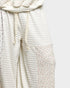 Light-colored textured fabric with floral trim on a white background