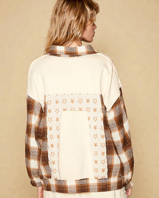 Person wearing a plaid shirt with star pattern on a beige background