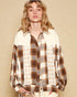 Woman wearing a plaid shirt with star patterns on a beige background