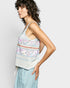 Woman wearing a floral tank top with a plain background