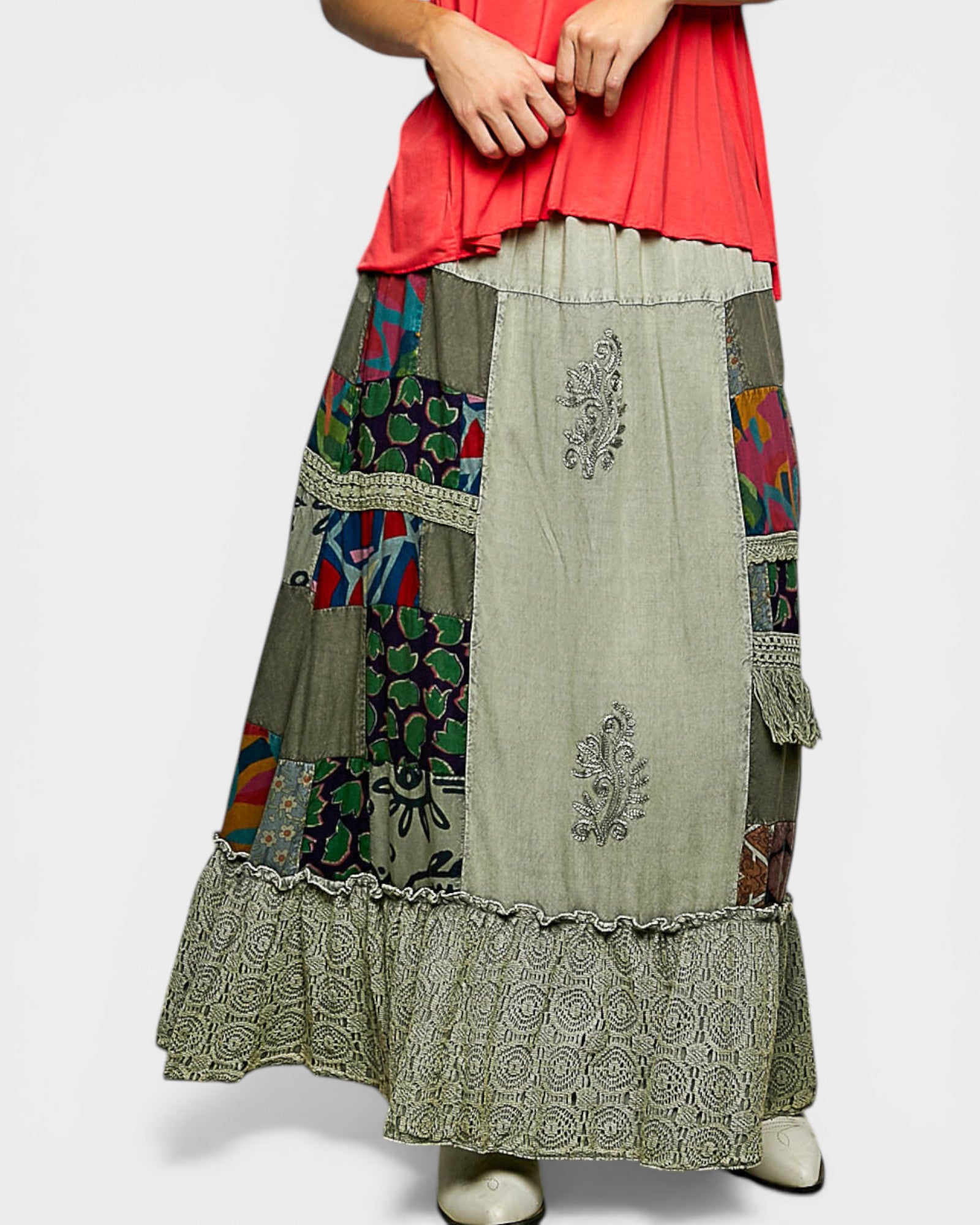 Long, patchwork skirt with floral and paisley patterns on a plain background