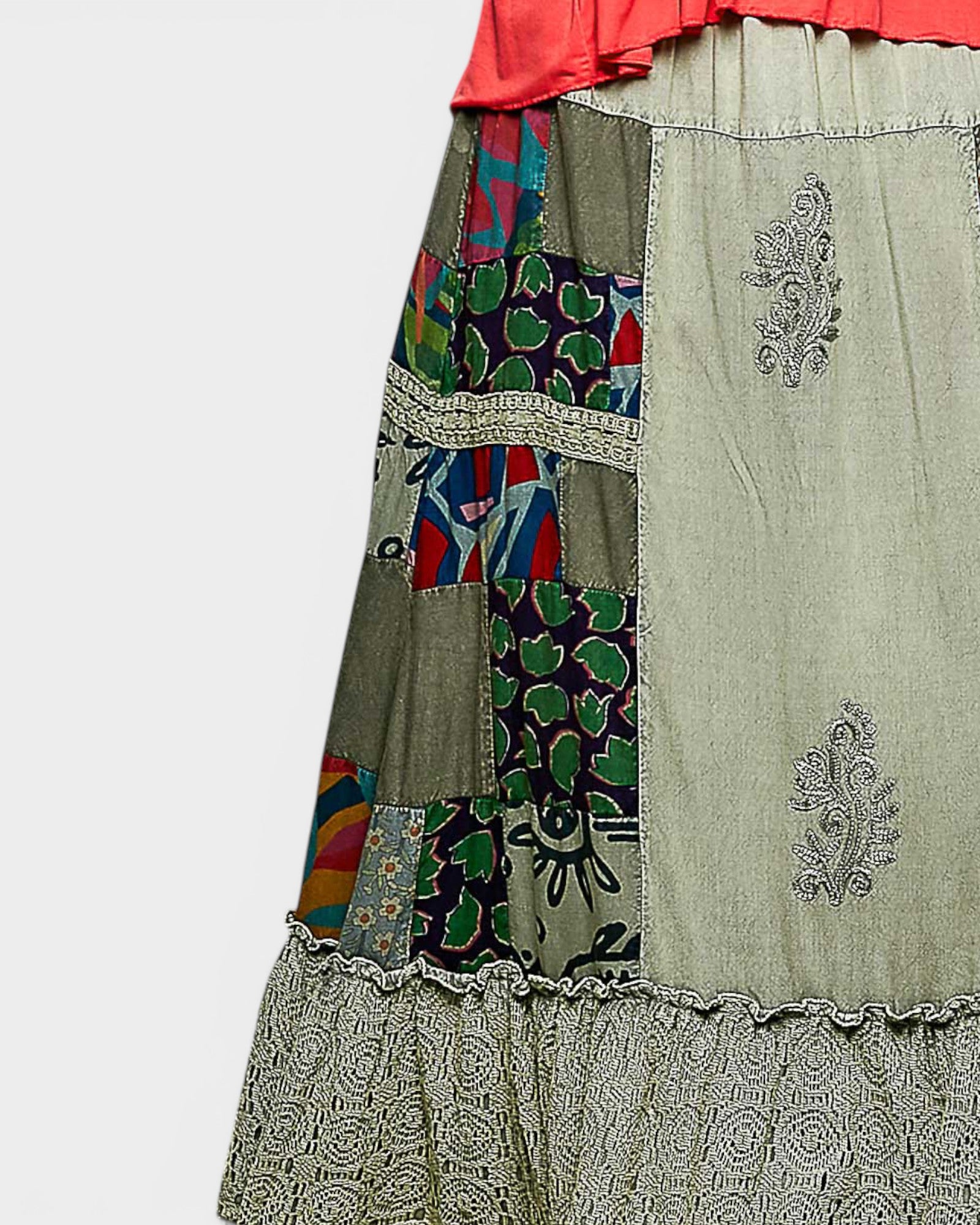 Patchwork skirt with colorful patterns and embroidery on a light gray background