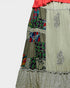 Patchwork skirt with colorful patterns and embroidery on a light gray background
