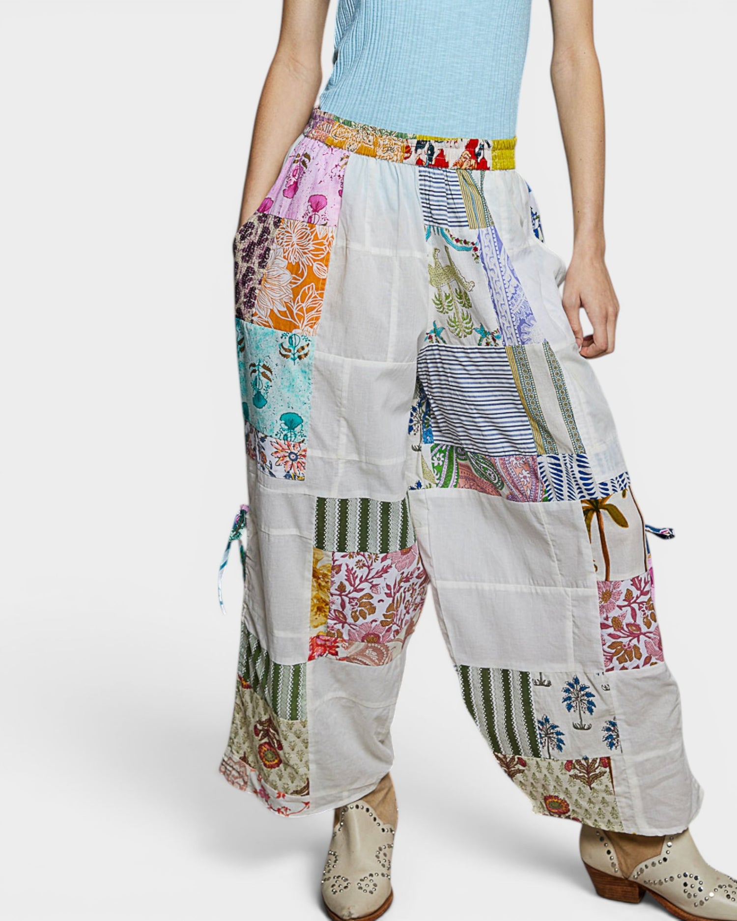 Colorful patchwork pants worn by a person on a white background