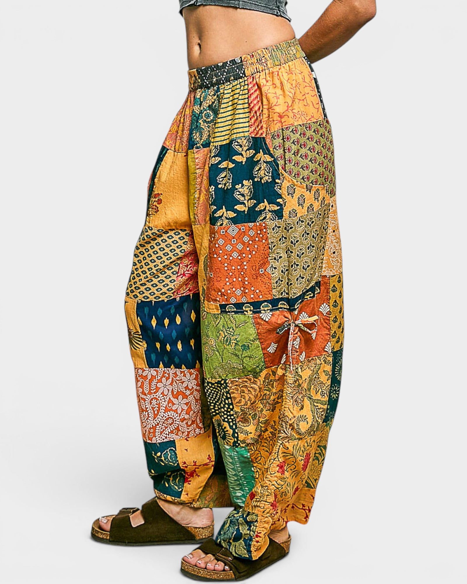 Colorful patchwork pants with a patterned design on a white background