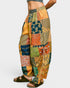 Colorful patchwork pants with a patterned design on a white background