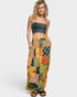 Woman wearing a colorful patchwork skirt and dark top on a white background