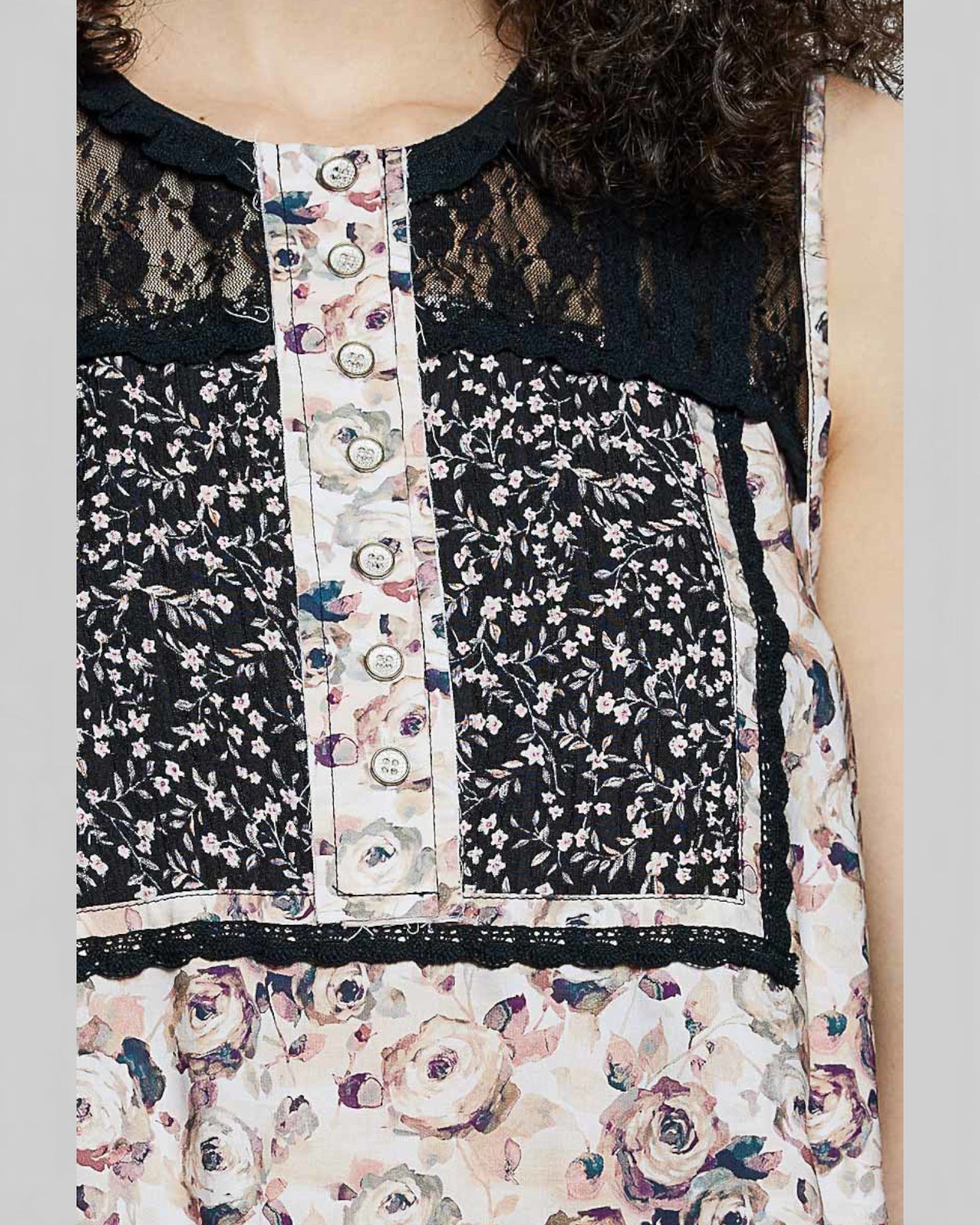 Floral patterned sleeveless top with lace details on a plain background