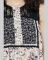 Floral patterned sleeveless top with lace details on a plain background