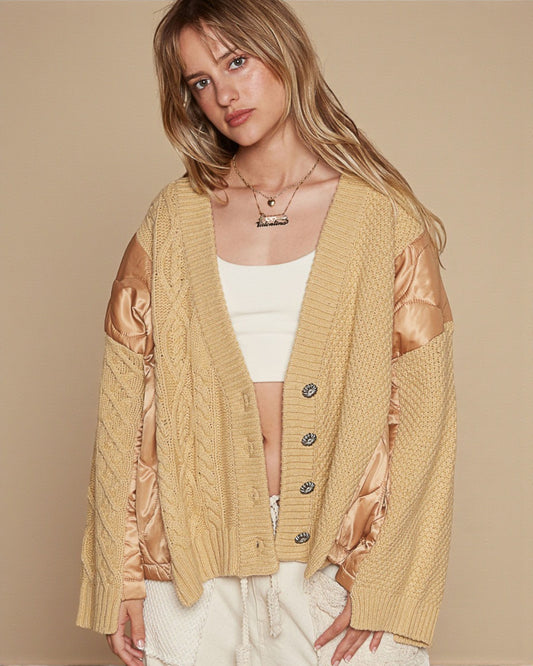 Woman wearing a beige cardigan with satin sleeves on a beige background