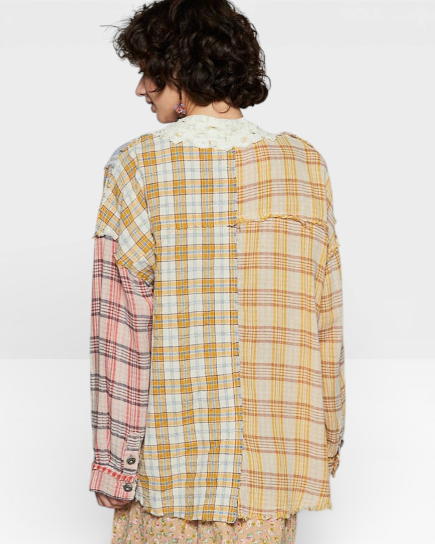 Person wearing a plaid shirt with a white background
