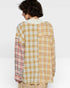Person wearing a plaid shirt with a white background