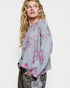 Woman wearing a floral blouse with a plain background