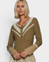 Woman wearing a brown long-sleeve top with lace details on a white background