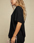 Woman wearing a black top with a beige background