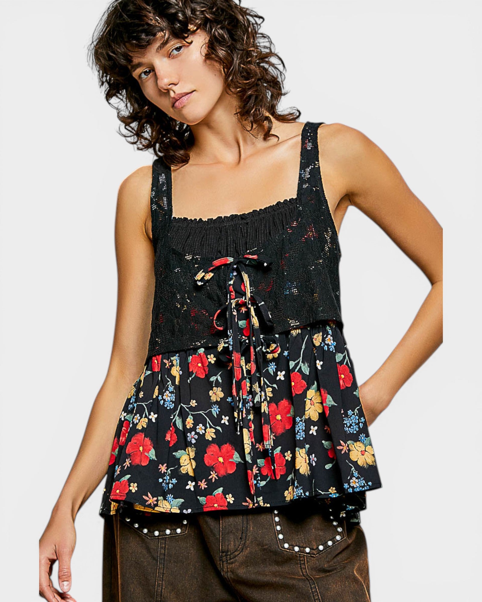 Woman wearing a black floral peplum top on a white background