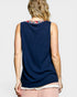 Woman wearing a navy sleeveless top with a colorful collar on a light gray background