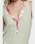 Green sleeveless top with floral neckline on a white background