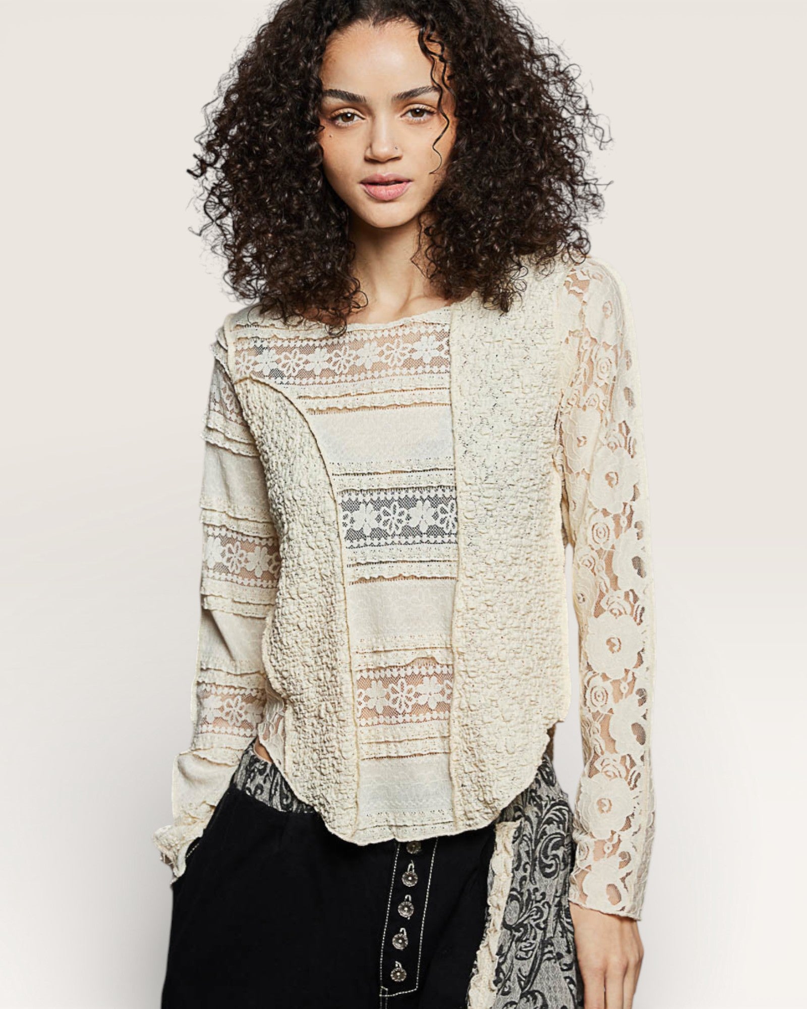 Woman wearing a patterned blouse with a plain background