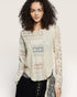 Woman wearing a patterned blouse with a plain background