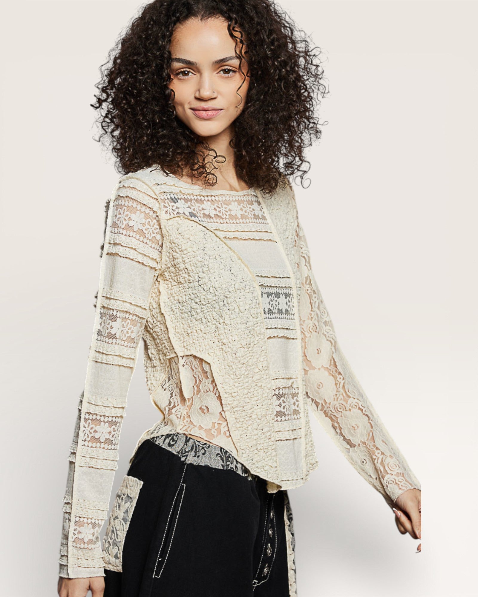 Woman wearing a patterned blouse with long sleeves on a plain background