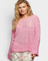 Woman wearing a pink knitted sweater on a white background
