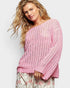 Woman wearing a pink sweater against a white background