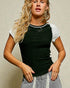 Woman wearing a black and white baseball shirt against a beige background